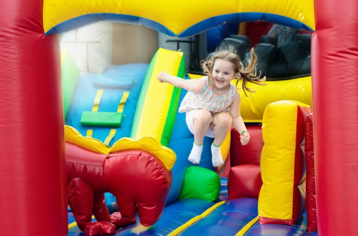 Child playing on inflatable jumping castle bounce house